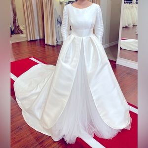 This is a beautiful modest wedding dress that is a size 4.